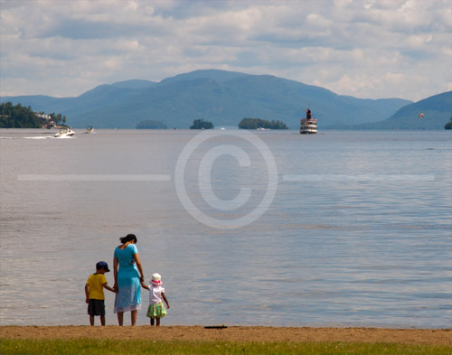 HD_P-37 - Mother with two young children walking on the beach near Lake George Village, New York.