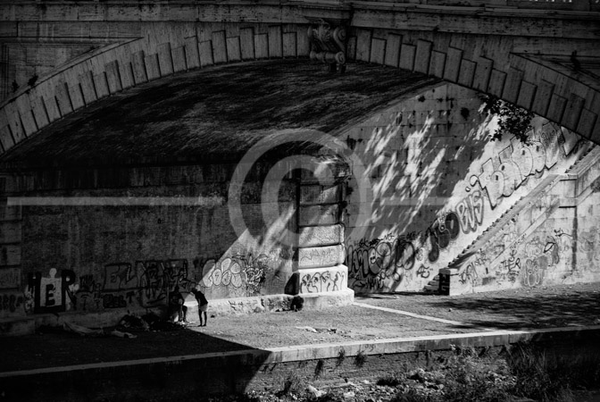 HD_STBW-21 - Homeless people under one of the massive bridges crossing the Tiber River in Rome, near the Vatican.