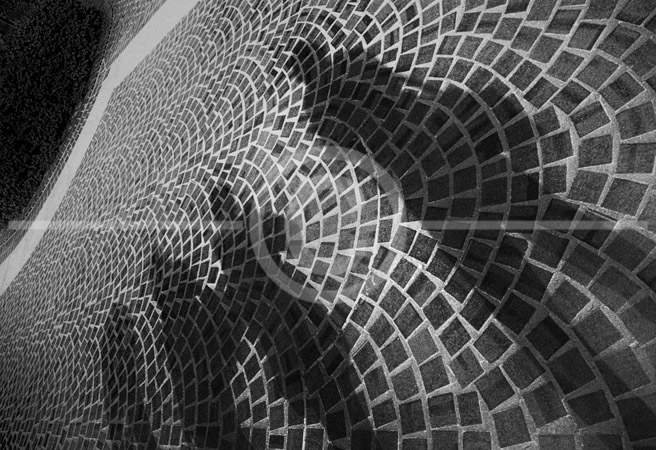 HD_STBW-84 - Shadows of 4 people waiting on line on pavers in a sidewalk.